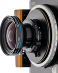 Photo of ARCA-SWISS Rm3di Technical Camera with quartering view, showing R-Line Lens. Featuring an award winning technical camera, a modular and expandable system, geared axis tilt built into the camera body and a helical focusing mechanism. From ARCA-SWISS USA. SKU: 017069.1